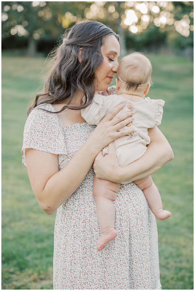 Mother Holds Infant Daughter And Leans In Close During Glenview Mansion Photos By Marie Elizabeth Photography