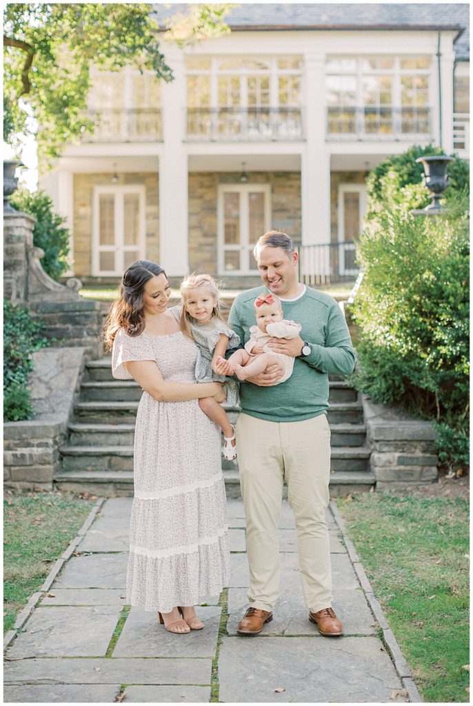 Family Of Four Stands In Front Of Glenview Mansion During Family Photos.