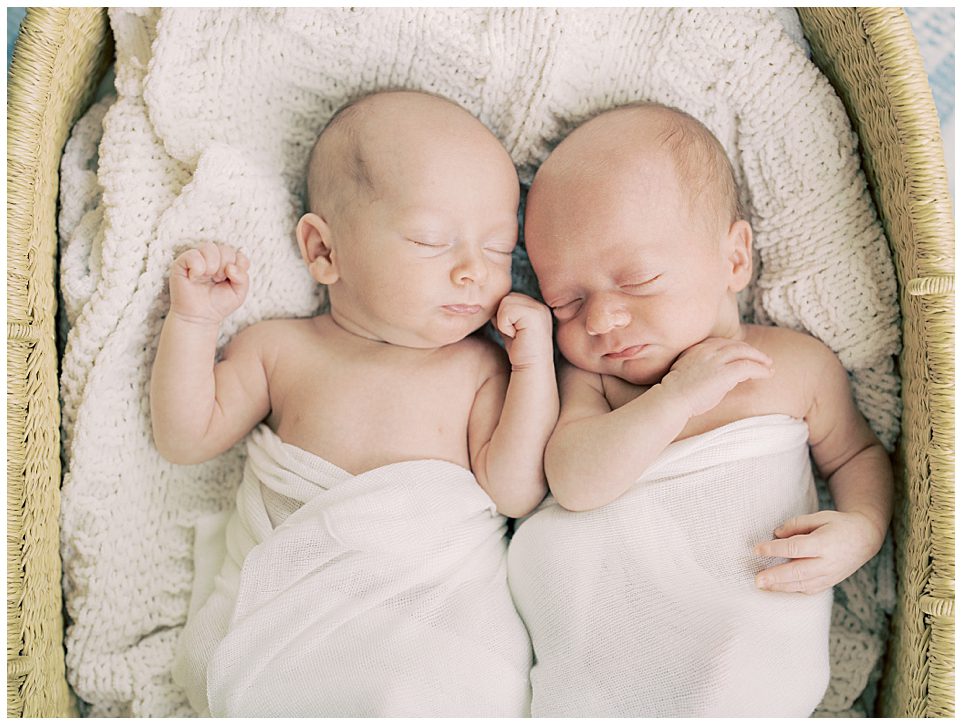 Twin Baby Boys Swaddled In White Sleep On A White Blanket, Photographed By Newborn Photographer Marie Elizabeth Photography.