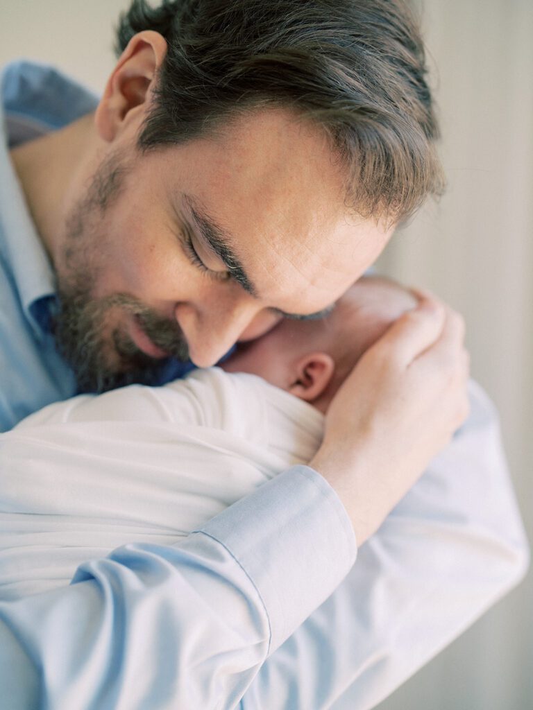 Father Brings Baby Up To Hug During A Silver Spring Md Newborn Session.