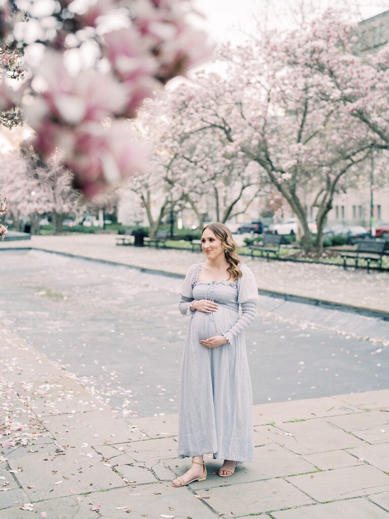 Pregnant Mother Stands In Rawlins Park In Dc During The Peak Magnolia Bloom.