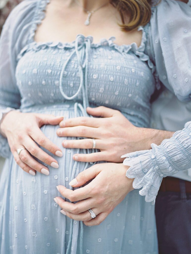 Close-Up View Of Hands On A Pregnant Belly.