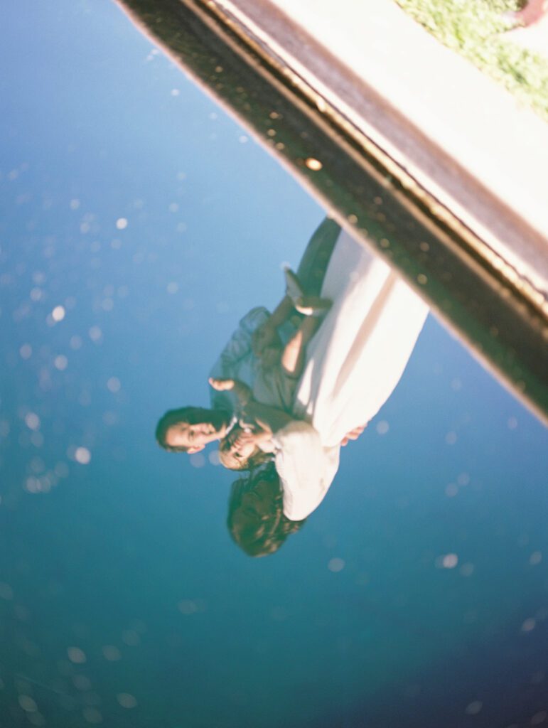 View Of Family In The Reflection Of A Pool Of Water, Photographed By Bethesda Photographer Marie Elizabeth Photography.