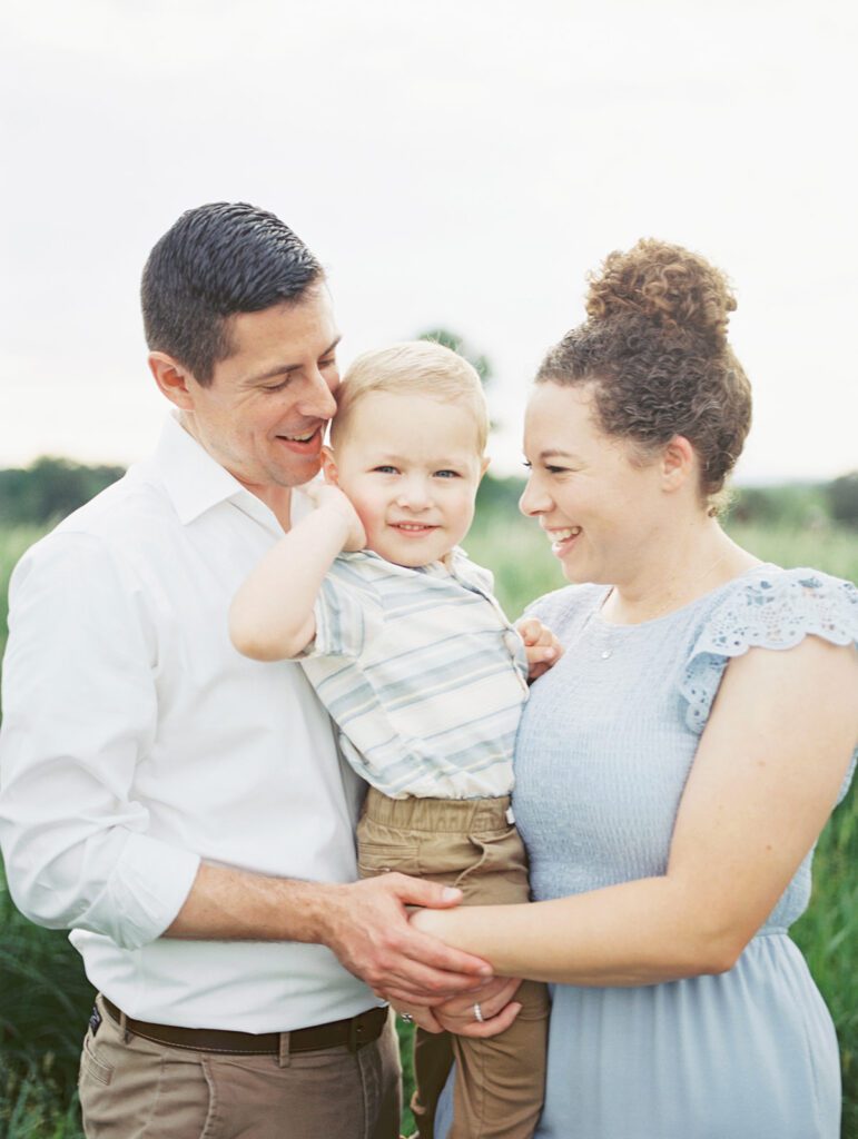 Parents Smile At Their Son As They Hold Him In Manassas Battlefield.