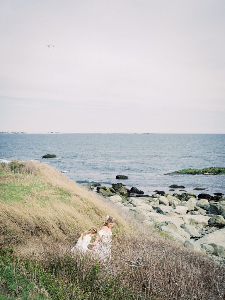 Mother Walks With Her Daughter Down To The Water, Photographed By Destination Family Photographer, Marie Elizabeth Photography.