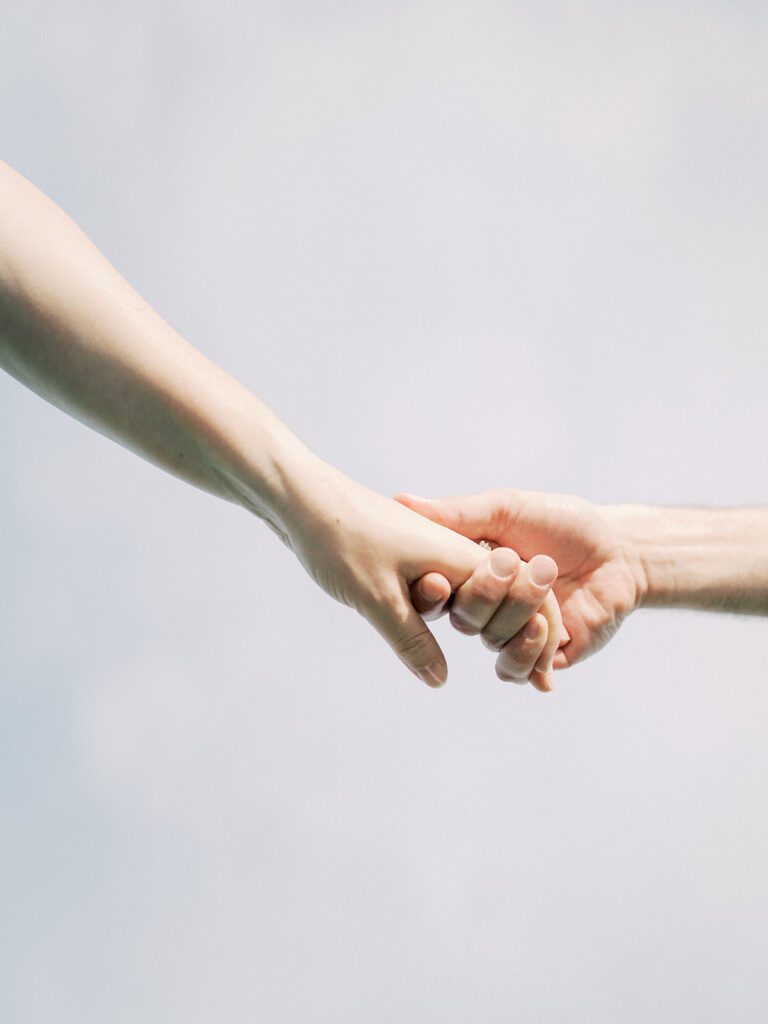 Close-Up View Of Two Hands Being Held.