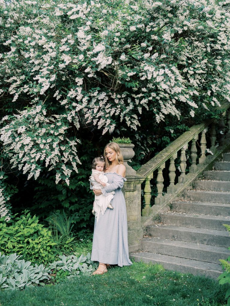 Bishop's Garden Photos Of A Mother Standing Holding Her Daughter In Front Of Stone Steps.