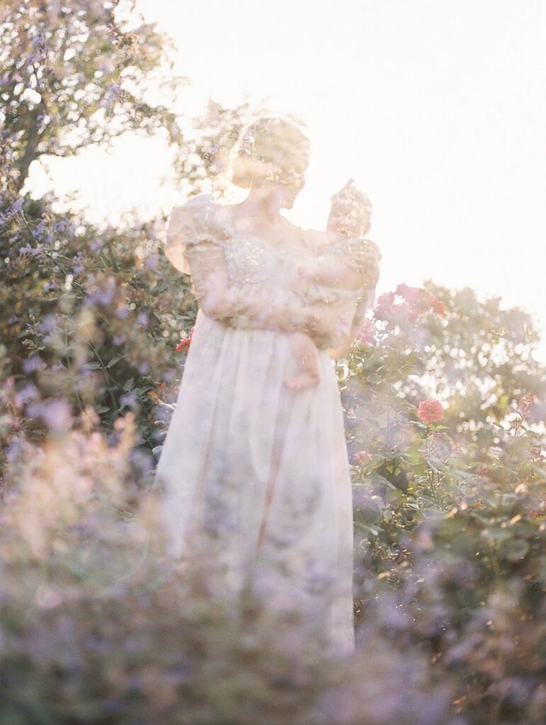 A Double Exposure Of Purple Flowers And A Mother And Baby.