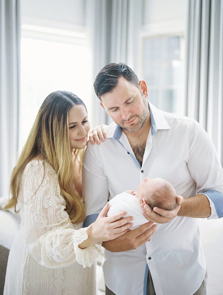 Mother And Father Admire Their New Baby During Their Olney Newborn Photos.