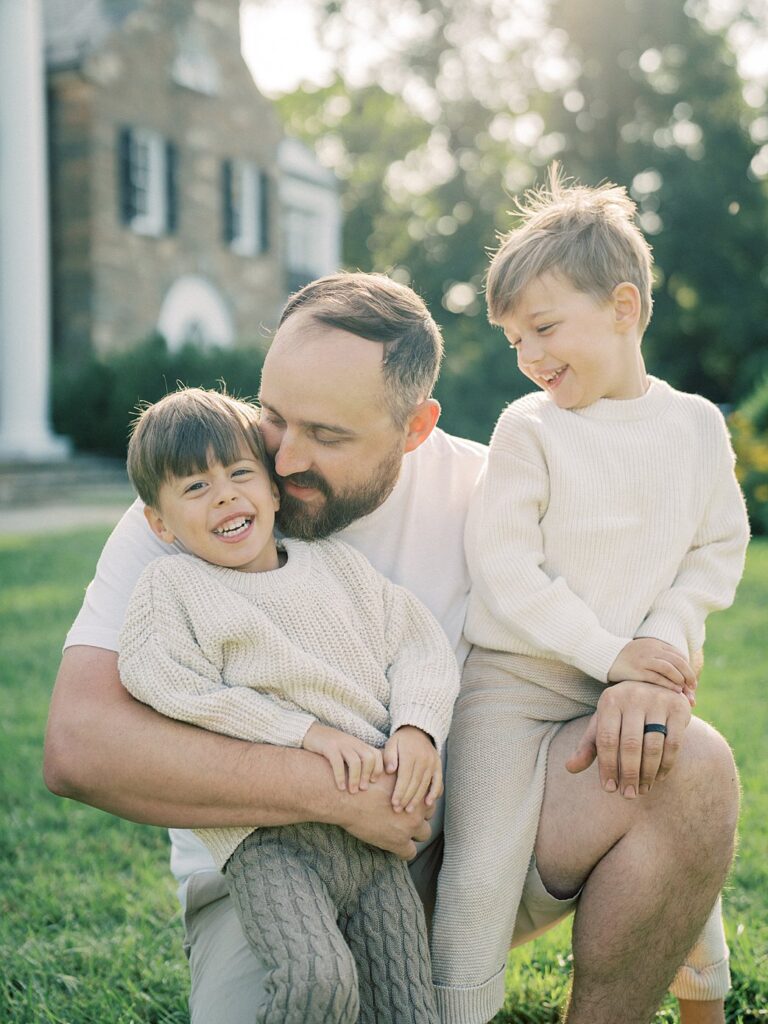 A Dad Crouches With Both His Young Sons During Their Rockville Md Family Photos.