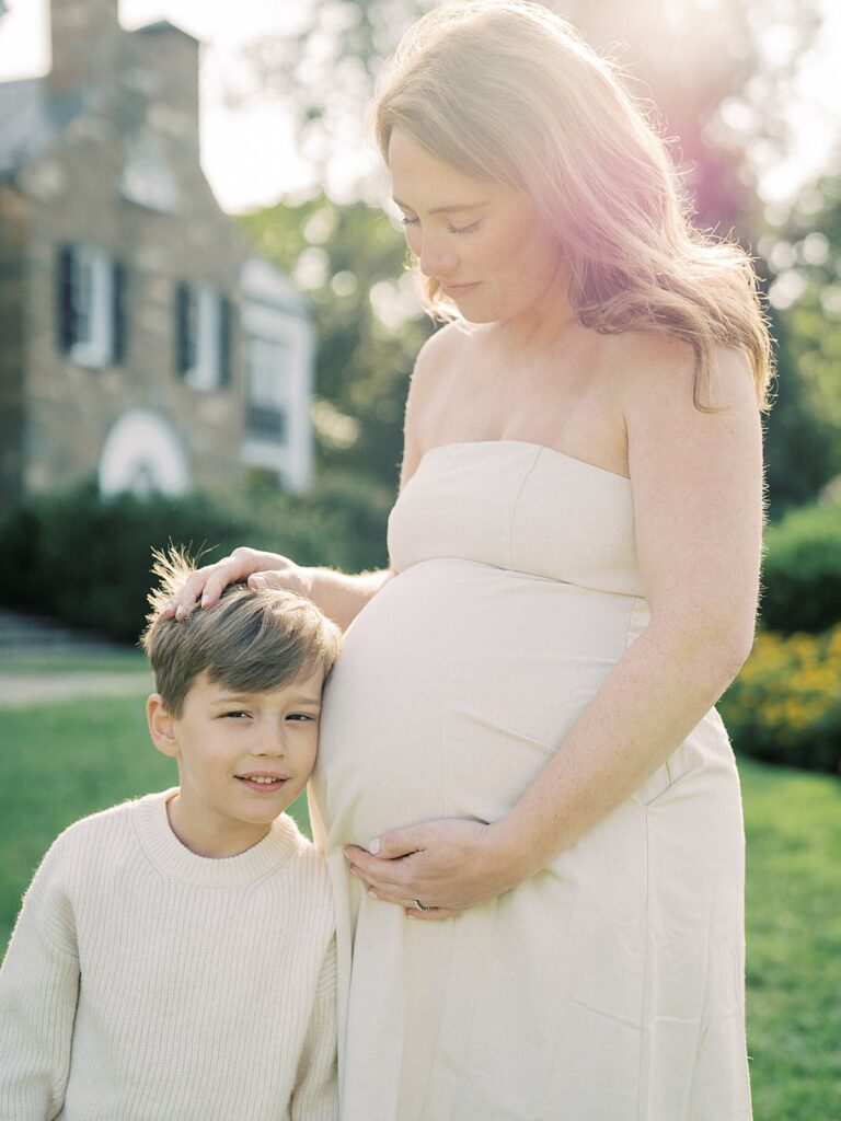 Mother With Red Hair Places A Hand On Her Son's Head, Photographed By Rockville Family Photographer Marie Elizabeth Photography.