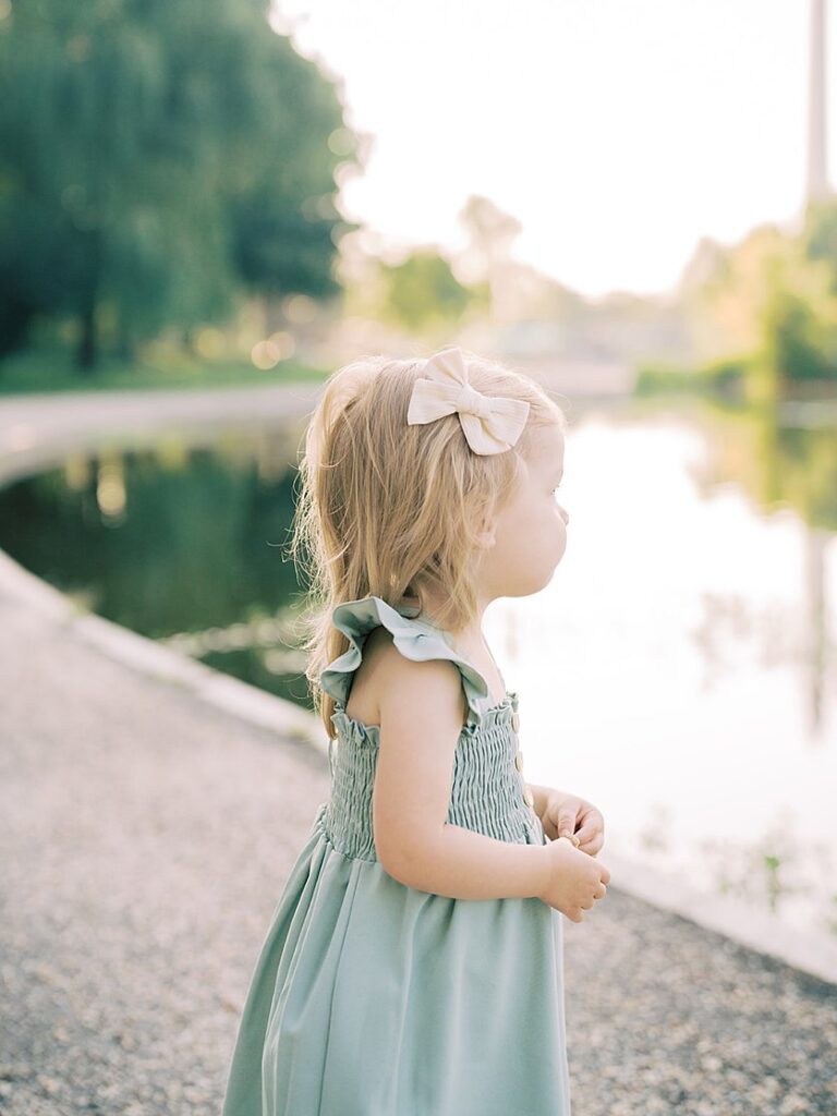 A Little Girl Looks Out At A Pond In Washington, D.c.