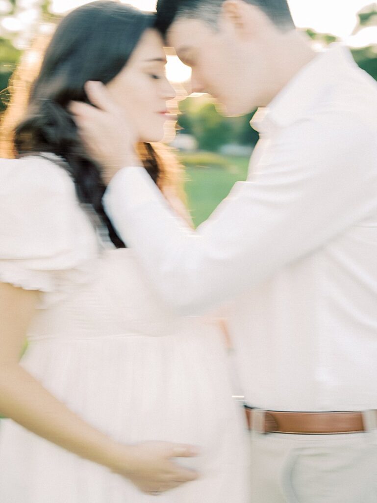 A Blurry Image Of A Couple Head-To-Head During Their Maternity Photos.