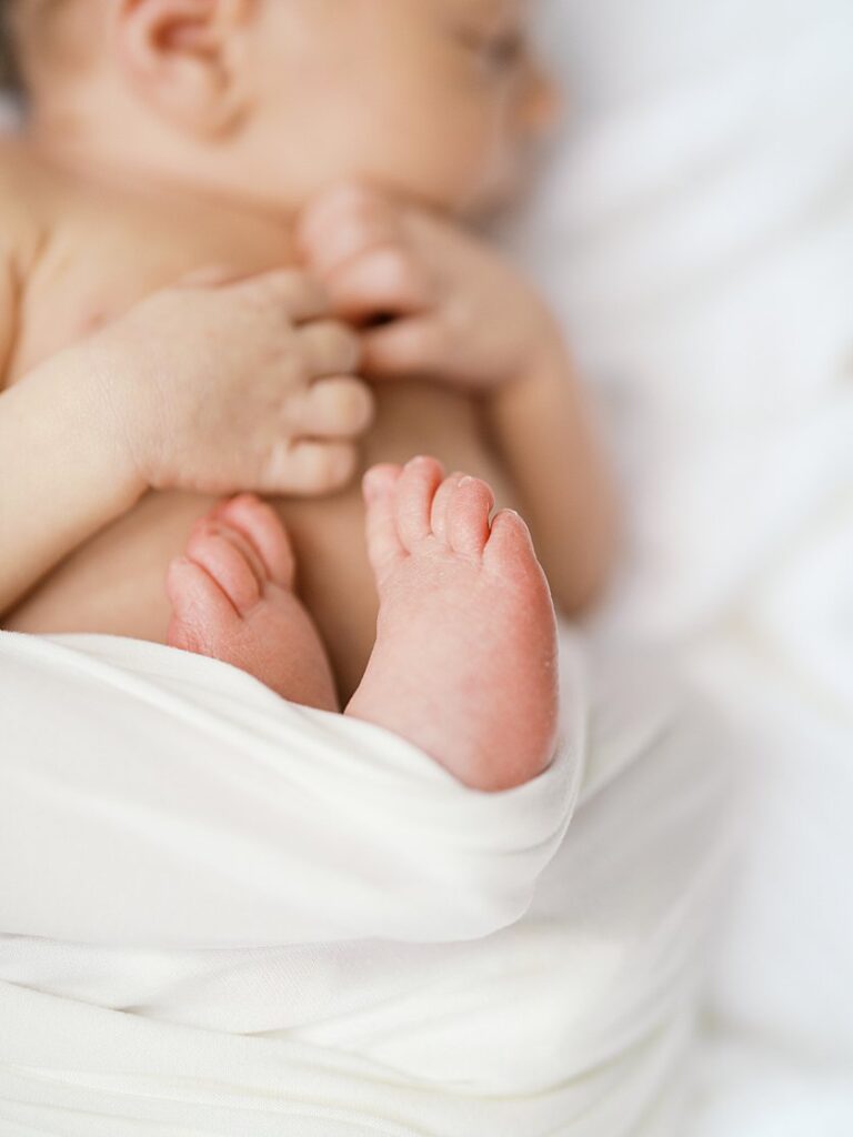 A Close-Up View Of Newborn Baby's Feet.