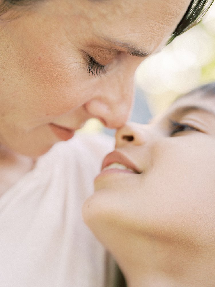 A Close-Up View Of A Mother And Son Going Nose-To-Nose.