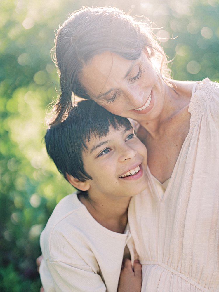 A Mother Smiles While Embracing Her 10-Year-Old Son During Their Great Falls Family Photos.