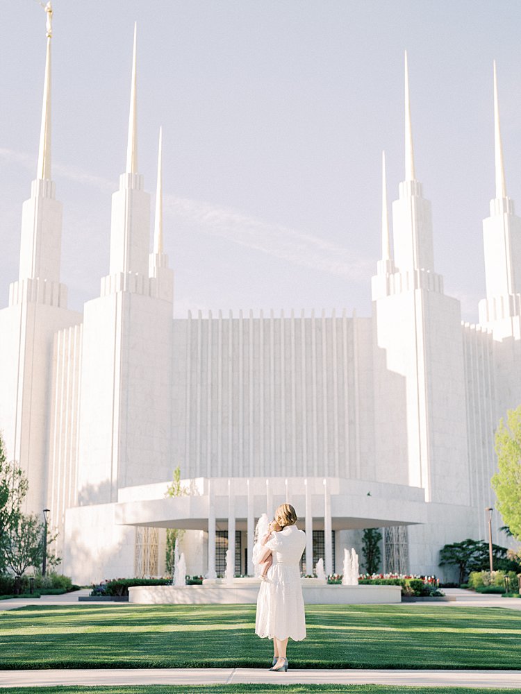 A Mother Holds Her Young Daughter During Their Mormon Temple Washington Dc Family Photos.