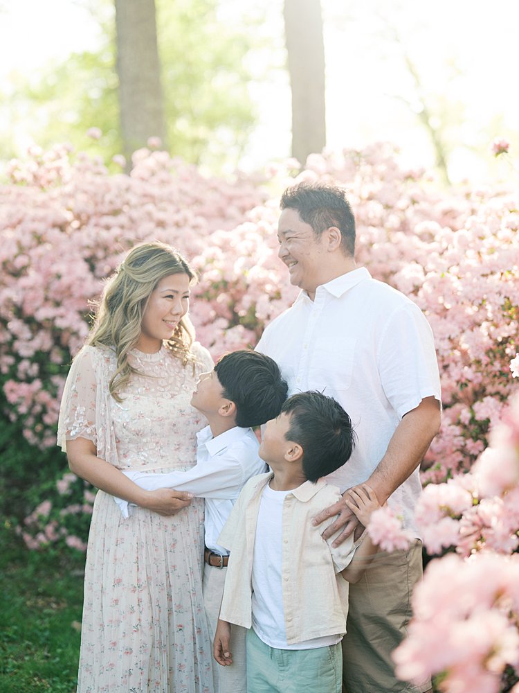 A Family Of Four Stands In The Brighton Dam Azalea Garden During Their Family Photos.