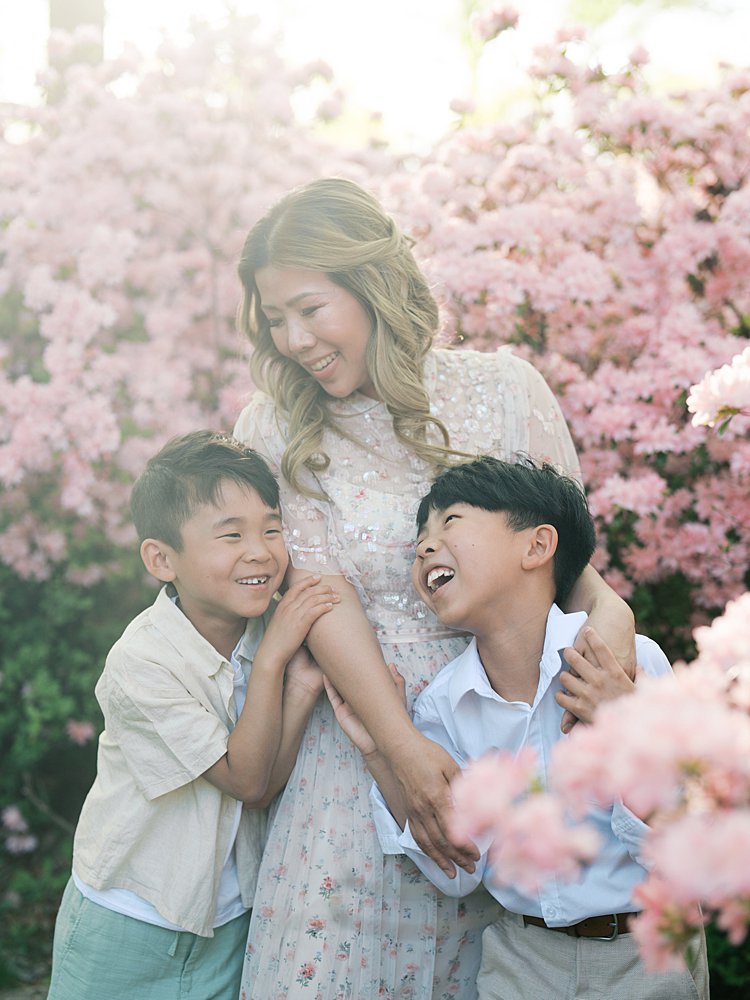 Two Sons Laugh And Hug Their Mother During Their Photo Session At The Azalea Garden.