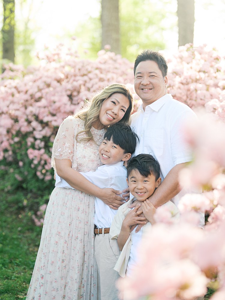 A Family Of Four Smiles At The Camera As They Stand In The Brighton Dam Azalea Garden In Brookeville, Maryland.