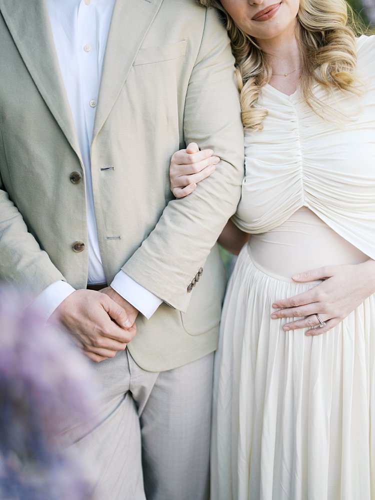 Close-Up View Of A Couple Standing Together During Their Maternity Session.