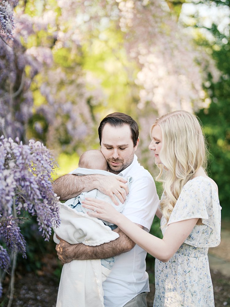 A Father Comforts His Baby Boy While Mother Also Places A Hand On Him During Their Family Photo Session With Wisteria In Dc.