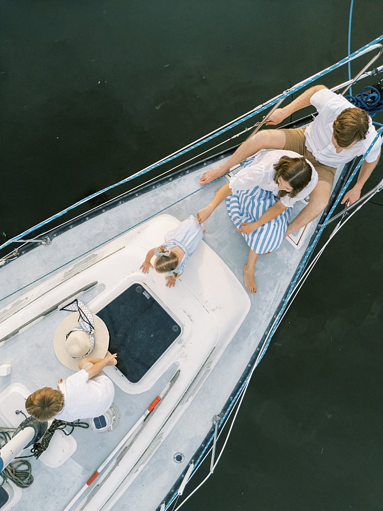 A drone shot of a family on a sailboat in Annapolis, MD.
