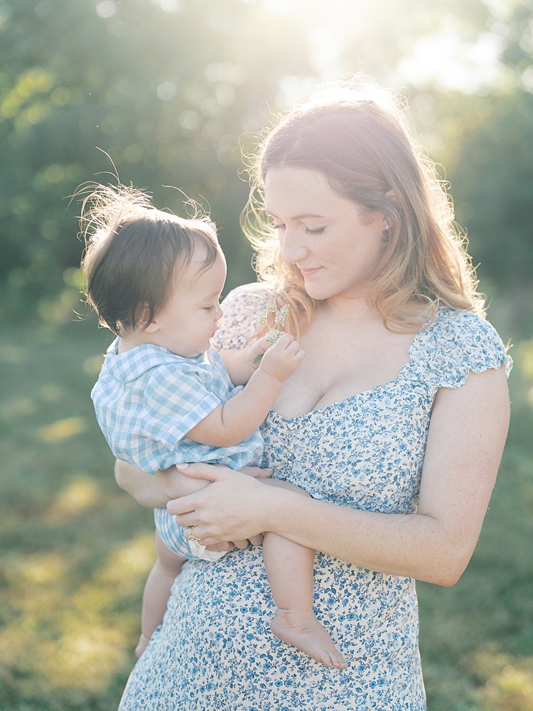 A Mother Holds Her Baby Son In A Field During Their Mayo Beach Park Photos.