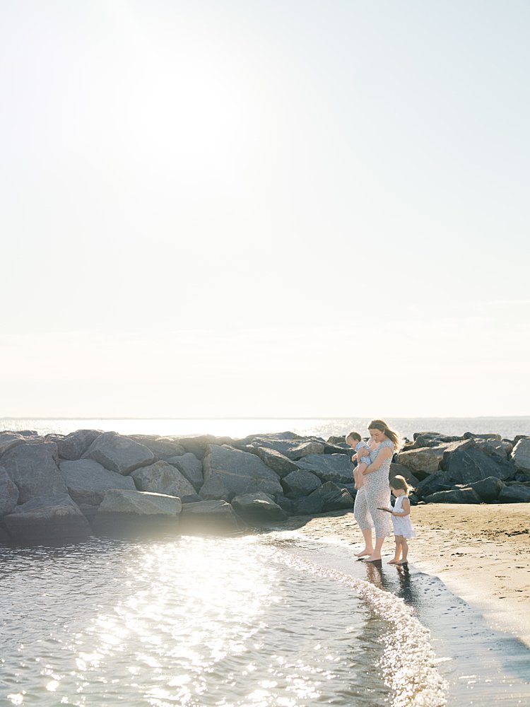 A Mother And Daughter Walk Along Mayo Beach In Edgewater, Maryland.