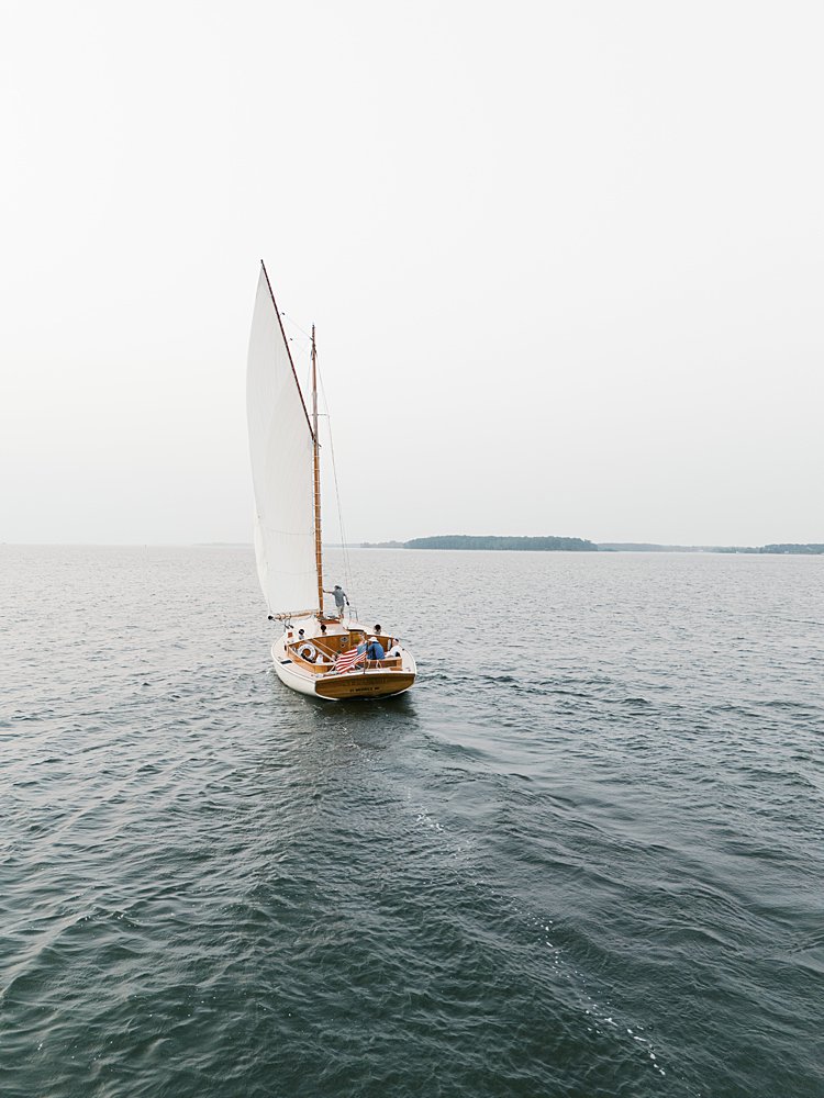 A sailboat sails long the water in St. Michael's, MD.