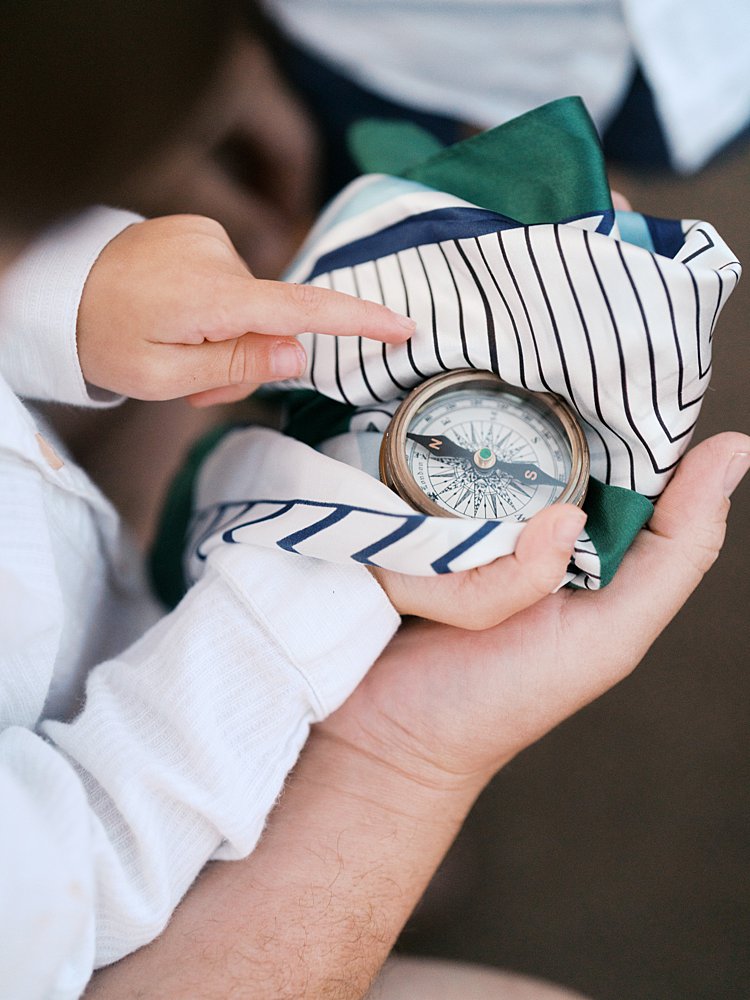 Vintage compass held in boy's hands.