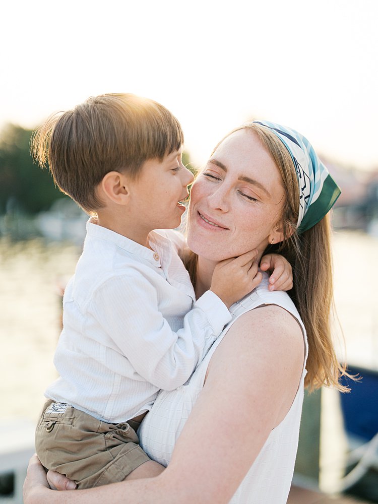 Little boy kisses his mother's cheek.