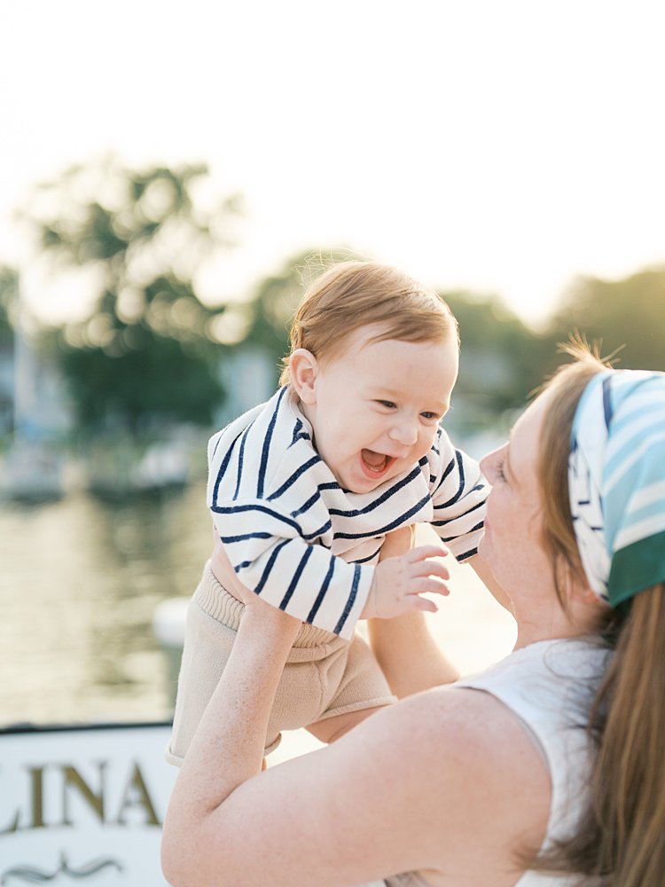 Baby boy smiles at his mother.