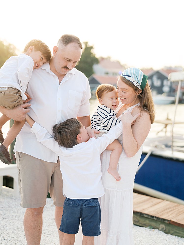 Little boys tickle their parents during their family photos along a dock in St. Michael's, MD.