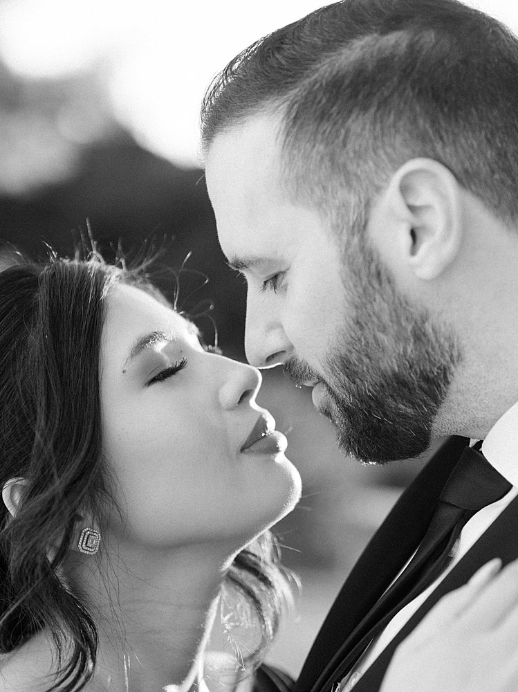 Close-Up View Of A Husband And Wife Going Nose To Nose In Black And White.