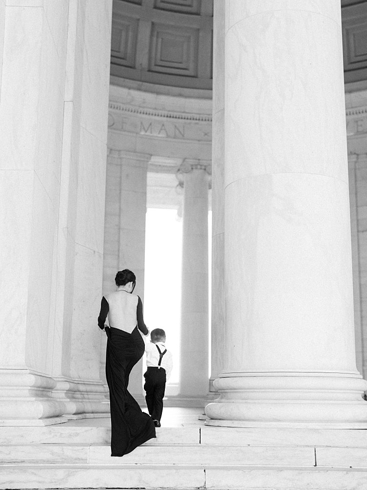 A Mother Walks Up The Steps Of The Jefferson Memorial With Her Son.