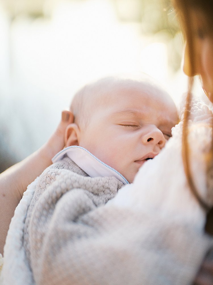 Baby Sleeps In His Mother's Arms.