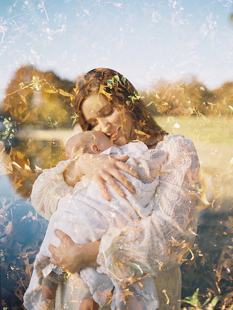 Double Exposure Of A Mom Holding Her Baby With Leaves.