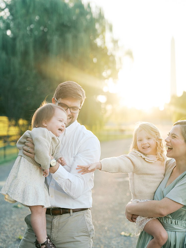 Big Smiles On A Family Of Four As They Tickle And Laugh.
