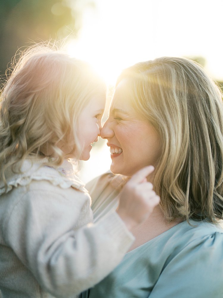 Mother And Young Daughter Nuzzle Their Noses Together During Their Downtown Dc Family Photos At Constitution Gardens.