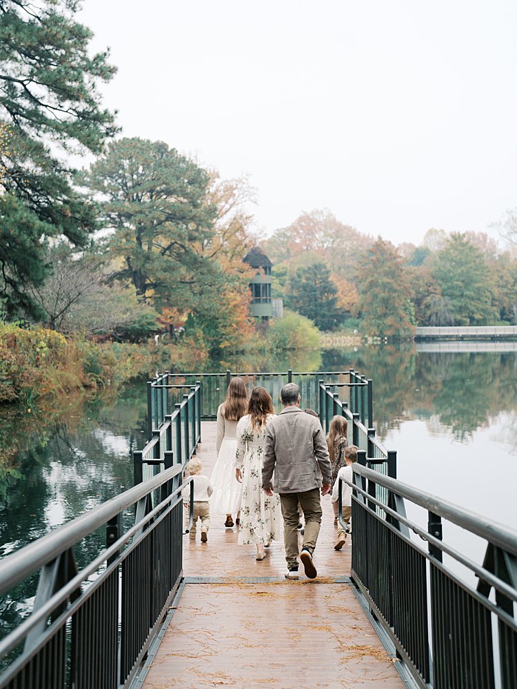 A Family Of Seven Walk Along A Dock At The Lewis Ginter Botanical Gardens.