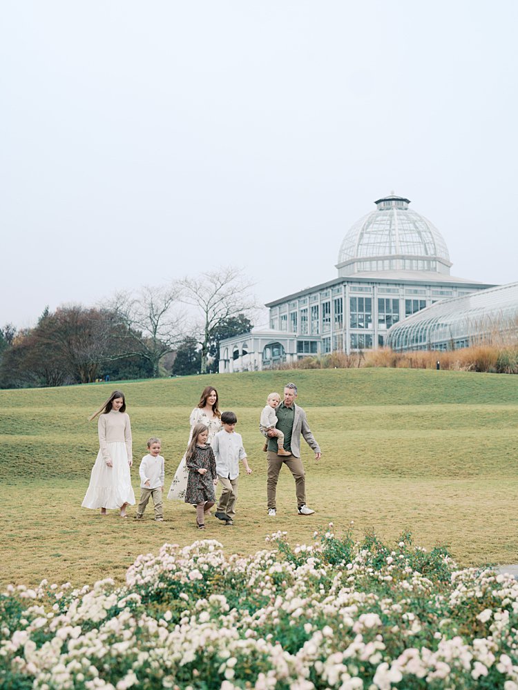 A Family Walks Along The Grassy Hill At Lewis Ginter Botanical Garden In Richmond, Virginia.