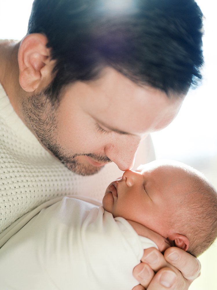 Father Leans Down To Go Nose To Nose With His Baby During Their Brookeville Md Newborn Photos.