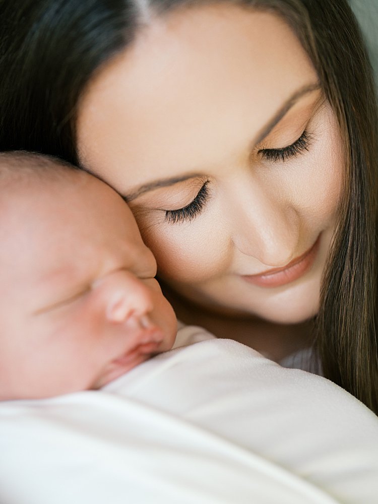Close-Up View Of Mother Leaning Her Head Down To Her Newborn Baby During Their Brookeville Md Newborn Photos.