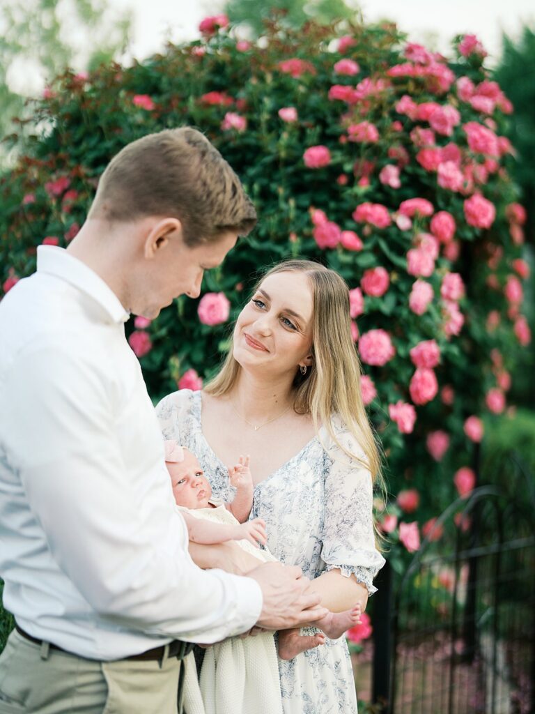 Wondering How Long Does A Newborn Session Take? Long Enough To Capture Soft, Unhurried Moments Like This One, With A Newborn Nestled Between Mom And Dad At Bon Air Rose Garden In Arlington, Va.