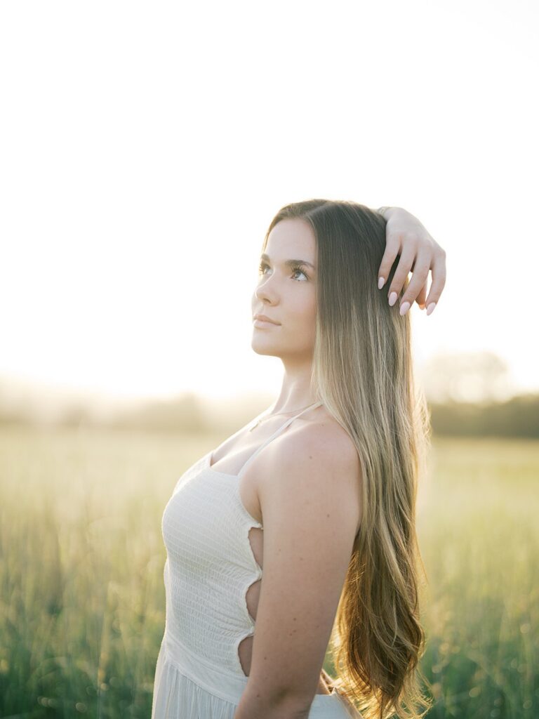 Teen Girl In A White Dress Gazing Into The Distance In A Golden Field, Photographed By A Gainesville Photographer Near Gainesville, Va