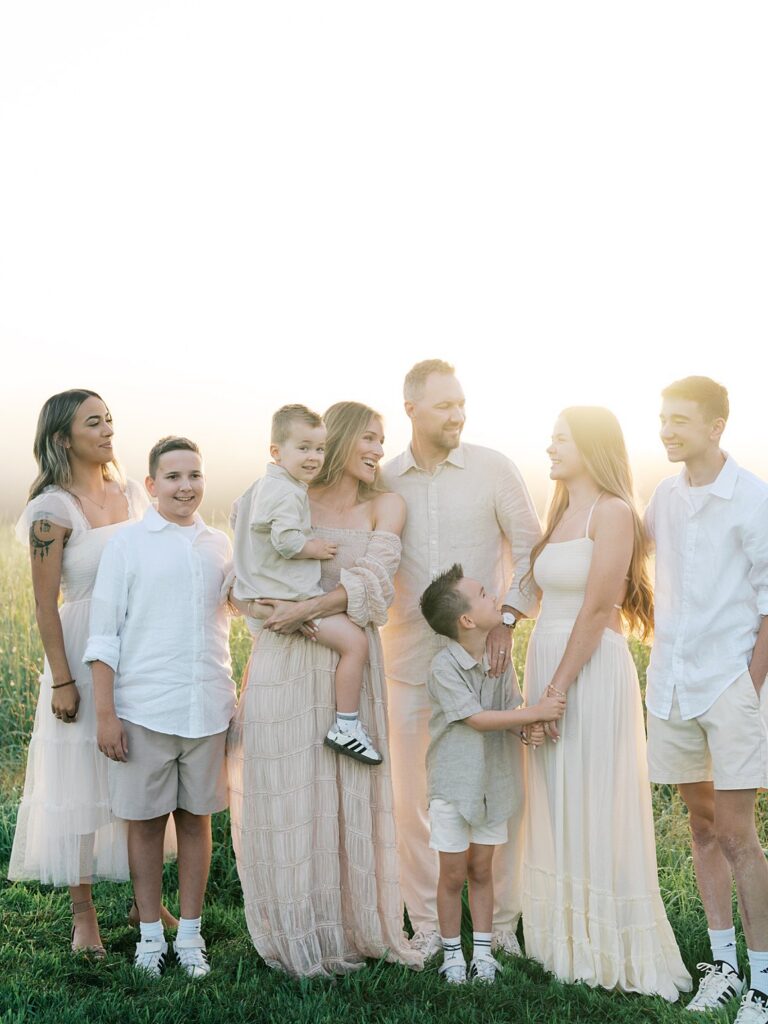 Large Family Of Eight Standing Together And Laughing In Soft, Hazy Golden Light At Manassas Battlefield