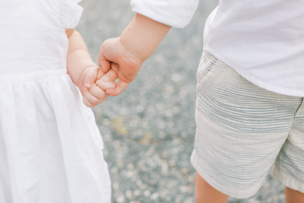 Two kids holding hands during Maryland family photo session.