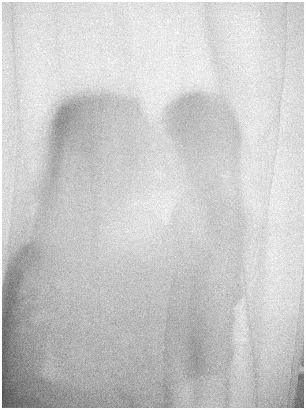 Mother and son behind a curtain.