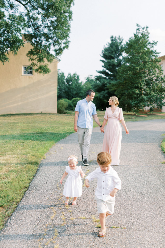 Two young children running ahead of their parents during a Maryland family photo session